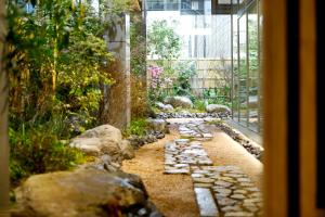 a garden with rocks and a walkway in a building at Travelodge Kyoto Shijo Kawaramachi in Kyoto