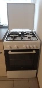 a white stove top oven sitting in a kitchen at Apartment Sonce in Koper