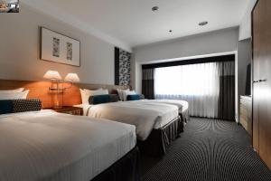 a hotel room with two beds and a window at Hotel New Otani Tokyo Garden Tower in Tokyo