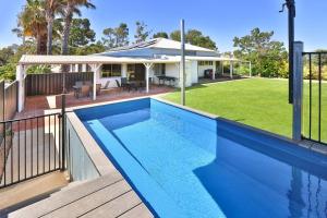 a swimming pool in front of a house at Kings Billabong Haven in Irymple
