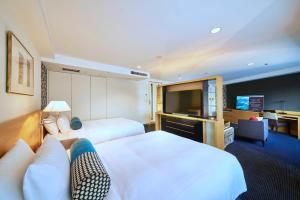 une chambre d'hôtel avec deux lits et une télévision à écran plat dans l'établissement Hotel New Otani Tokyo Garden Tower, à Tokyo 76 autres photos