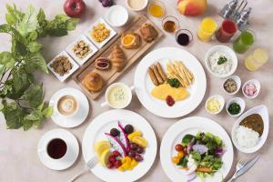 a table topped with plates of food and drinks at Hotel Metropolitan Edmont Tokyo in Tokyo