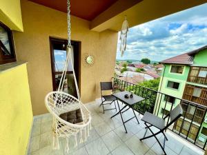 a porch with a hammock and a table and chairs at Apartament Novara 2 in Craiova