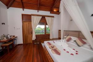 Postel nebo postele na pokoji v ubytování Popa Garden Resort