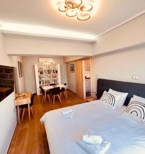 a bedroom with a large bed and a table at Urban House Aiolou in Athens