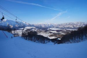 a ski slope with people on a ski lift at Hotel Onikoube in Osaki