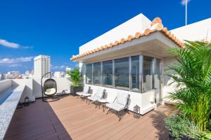 a house with a deck with chairs on it at アルファベットイン那覇国際通りEAST in Tsuboya