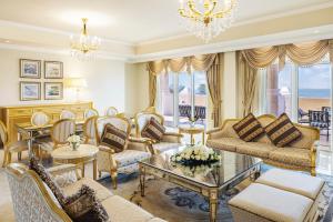 a living room with furniture and a chandelier at Kempinski Hotel & Residences Palm Jumeirah in Dubai