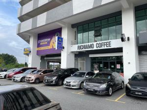 a row of cars parked in a parking lot in front of a building at H&Z HOMESTAY @ VISTA BANGI in Kajang