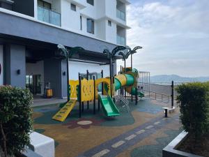 a playground in front of a building with a slide at H&Z HOMESTAY @ VISTA BANGI in Kajang