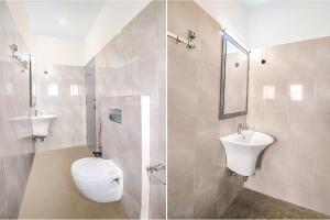 a white bathroom with a toilet and a sink at FabHotel Airport Green Arcade in Kolkata