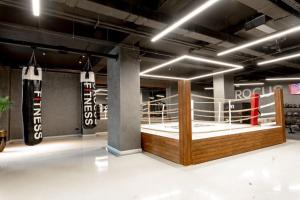 a room with a boxing ring with boxing gloves at Sabah Residance in Baku