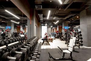 a gym with rows of chairs and machines at Sabah Residance in Baku