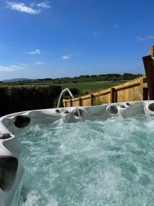 a swimming pool with water pouring out of it at Bay View Luxury Stays - Southdown in Overcombe
