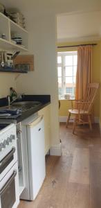 a kitchen with a sink and a stove top oven at Polmarine in Polruan