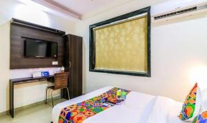 Un dormitorio con una cama y un televisor en una habitación. en FabHotel Galaxy Suite, en Bombay