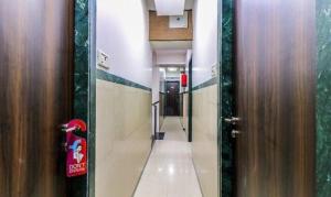 a hallway with two wooden doors and a long corridor at FabHotel Galaxy Suite in Mumbai