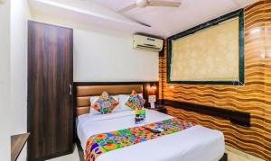 a bedroom with two beds and a large window at FabHotel Galaxy Suite in Mumbai +16 photos