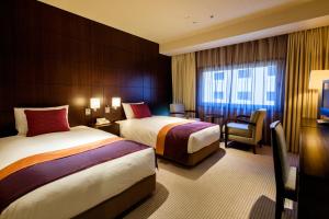 En eller flere senge i et værelse på Hotel Metropolitan Edmont Tokyo