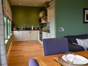 a kitchen and a dining room with a table and a kitchen at Strathspey in Grange