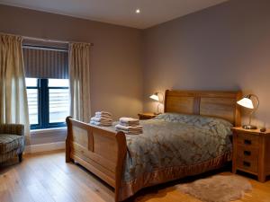 a bedroom with a bed with two lamps and a window at Strathspey in Grange