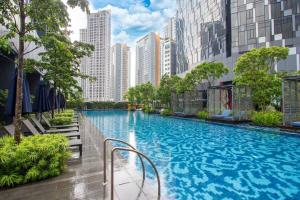 a large swimming pool in a city with tall buildings at Star Residences KLCC in Kuala Lumpur