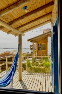 a hammock on the deck of a house at CABANAS Villa Del Mar in Farol de Santa Marta