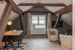 a room with a table and chairs and a window at FACT Apartments in Arnoldstein