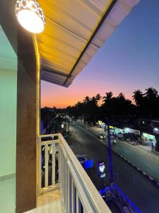 a balcony with a light and a street at night at Hotel Sai Advika in Mapusa