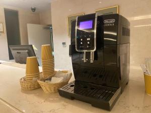 a pay phone sitting on top of a coffee machine at Forest Hongo by unito in Tokyo