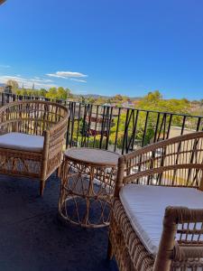 two wicker chairs and a table on a balcony at Commercial Hotel Bega in Bega