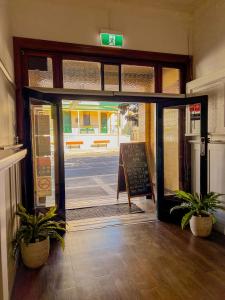 an entrance to a building with a door open at Commercial Hotel Bega in Bega