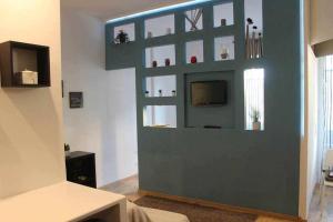 a living room with a blue wall with a tv at Lovely Firenze Open spaceCentrale Turismo e Work in Florence