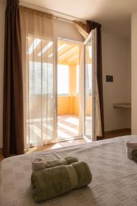 a bedroom with a bed with a large sliding glass door at MARIS Apartments & Bedrooms in Alghero