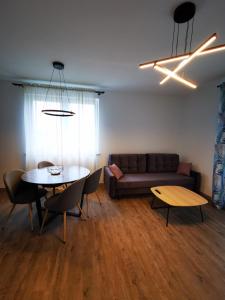 a living room with a couch and a table at Akacjowy Apartament in Sianozety