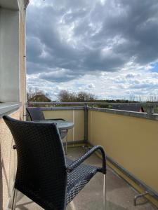 a balcony with a chair and a table on a roof at Gästewohnung KL. WZL 29_7 in Klein Wanzleben