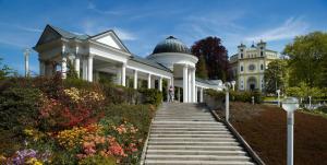 a white house with a staircase leading up to it at Hotel Excelsior in Mariánské Lázně