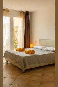 a bedroom with a bed with two towels on it at MARIS Apartments & Bedrooms in Alghero
