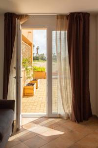a room with a door open to a patio at MARIS Apartments & Bedrooms in Alghero
