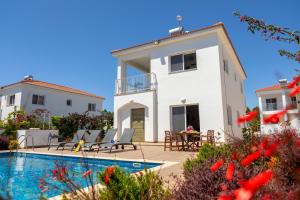 a villa with a swimming pool and a house at Napa Bay View Villa 3 in Ayia Napa