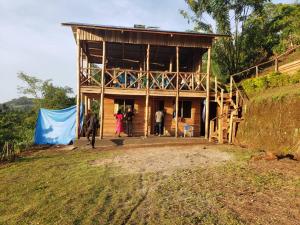 a group of people standing outside of a building at Noah's Ark Campsite & Restaurant in Fort Portal