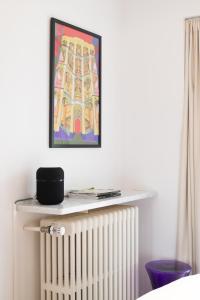 a picture hanging on a wall above a radiator at Blue dunes, Knokke in Knokke-Heist