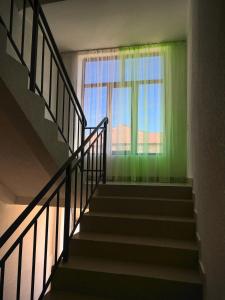 a stairway with a green wall and a window at Гостевой дом Крылья in Cholpon-Ata