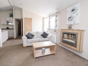 a living room with a couch and a fireplace at Rosella 38 in Morecambe
