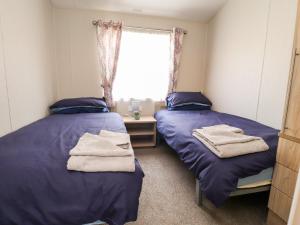 En eller flere senge i et værelse på Rosella 38