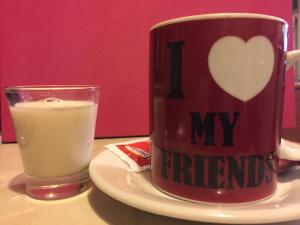 a cup of coffee and a glass of milk on a plate at My Friends in Florence