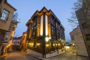 a large wooden building on a street at night at GLK PREMIER Sea Mansion Suites & Spa - Special Class in Istanbul