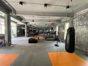 a large room with a gym with a swing at Extra large, modern apartment with sea view in Bang Rak Beach