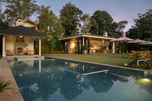 a house with a swimming pool in front of a house at Stafford Bungalow in Nuwara Eliya