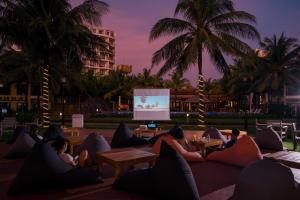 a group of people sitting on a couch watching a screen at Famiana Resort & Spa in Phu Quoc